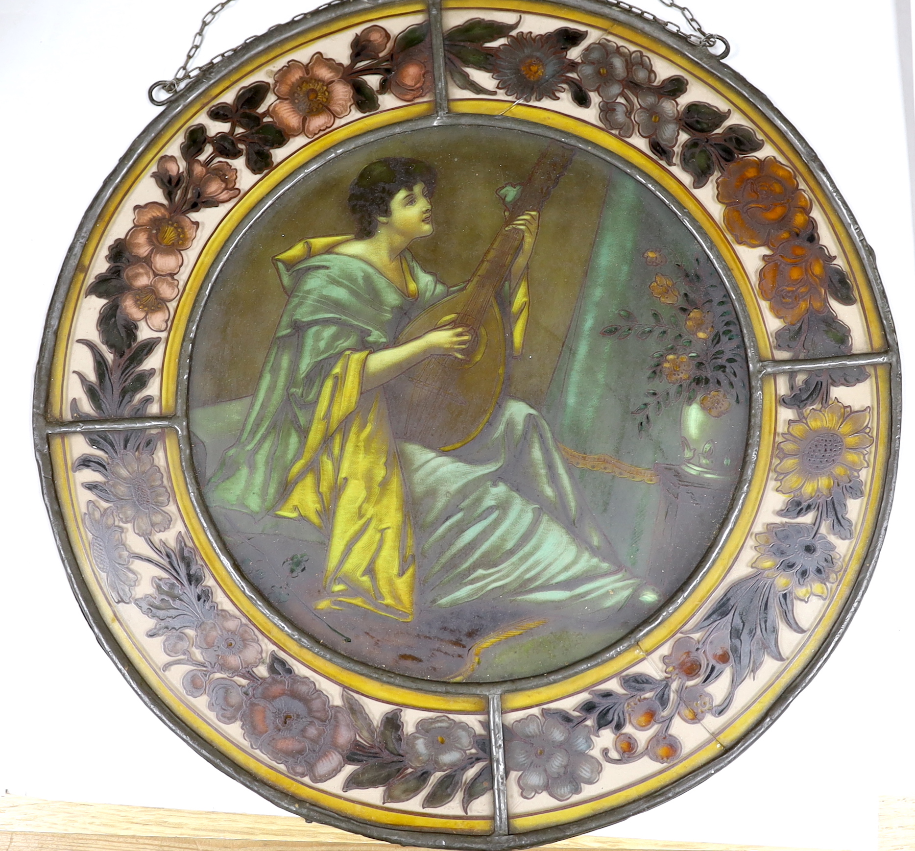 Two Victorian stained glass leaded roundels, one depicting a gentleman playing a lute, 32cm in diameter